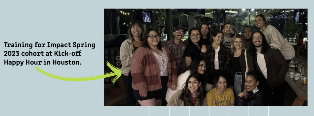 A group of approximately fourteen Training for Impact Spring 2023 cohort members pose together at an outdoor evening venue in Houston for their Kick-off Happy Hour. The group is arranged in two informal rows, smiling at the camera. String lights and trees are visible in the background.